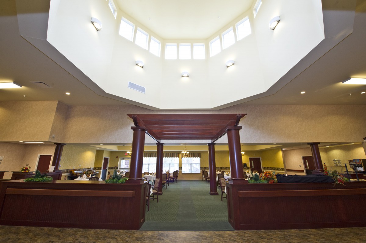 An elegant interior space with a high ceiling and structured seating area.