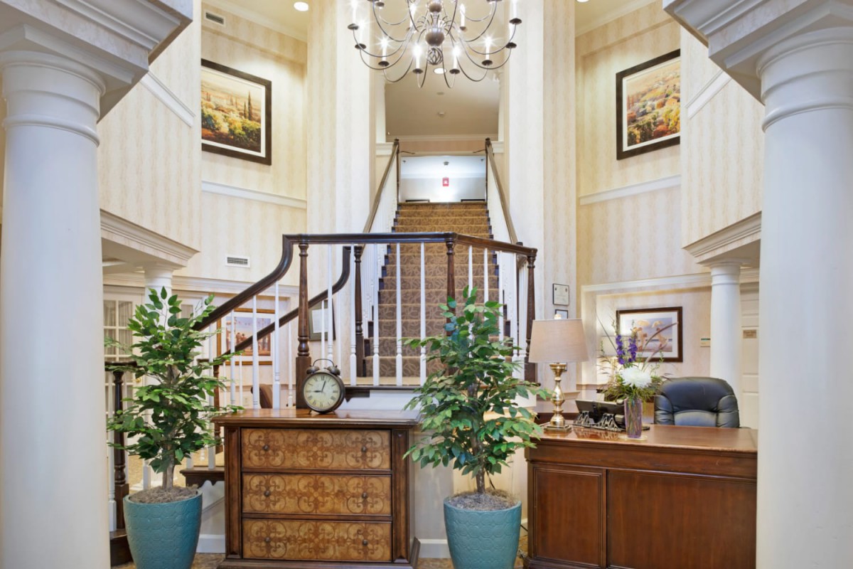 Elegant lobby with a grand staircase and sophisticated decor.