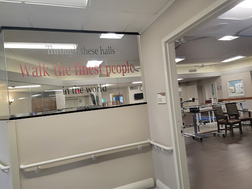 A view of a hospital corridor with a focus on signage indicating the area.