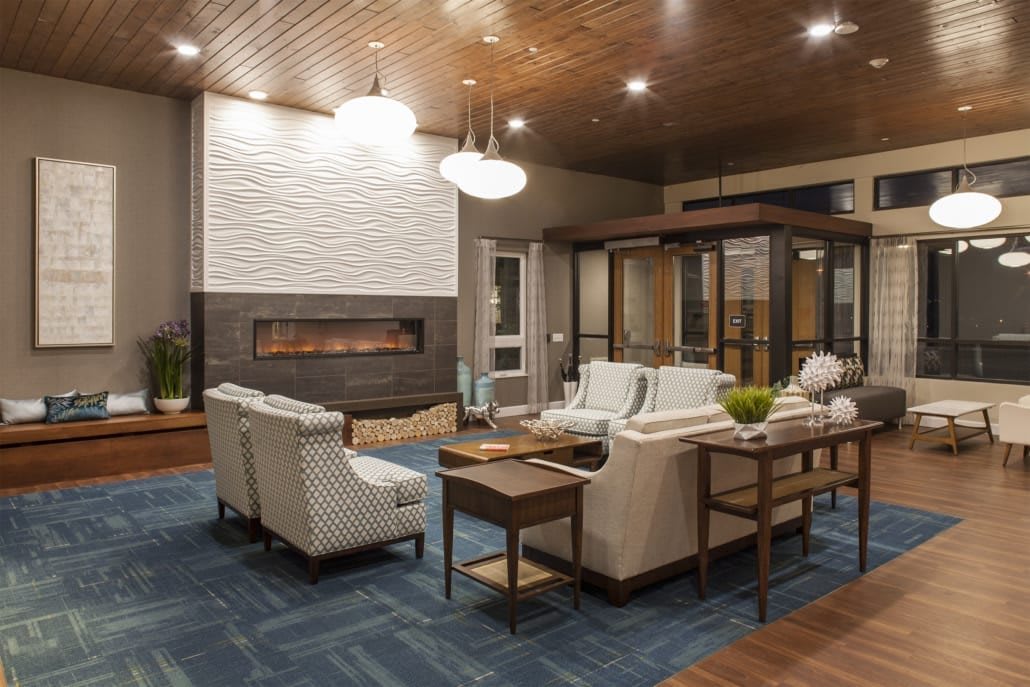 A modern living room with a fireplace and stylish seating area.