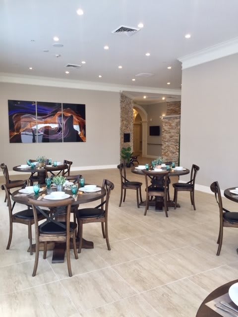 An elegant restaurant interior with neatly arranged tables and chairs.