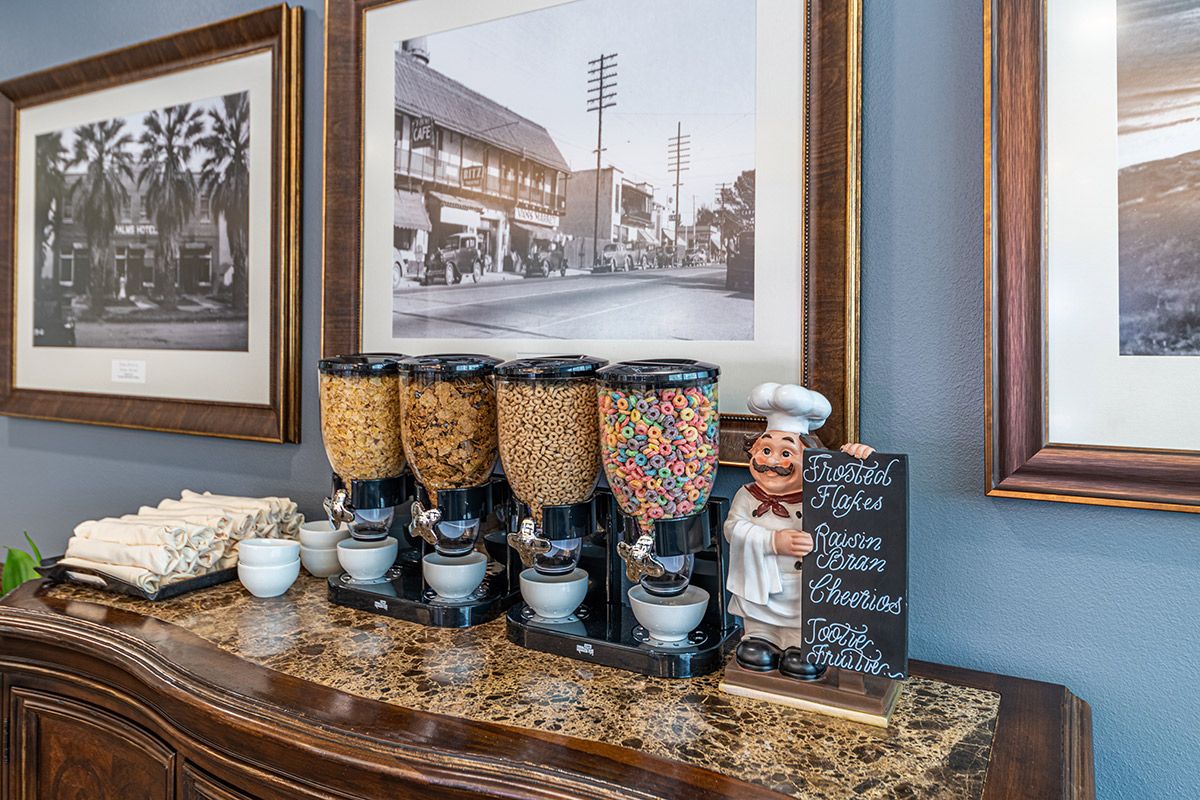 A breakfast buffet with a variety of cereal dispensers and decor.