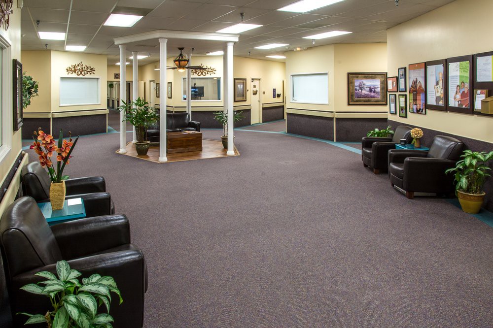 A spacious waiting area with comfortable seating and decorative accents.