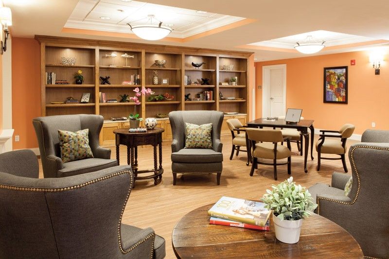 A cozy living room with comfortable seating and bookshelves, perfect for relaxing and reading.