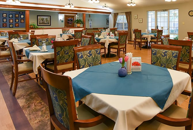 Elegant dining room with neatly set tables and comfortable seating.