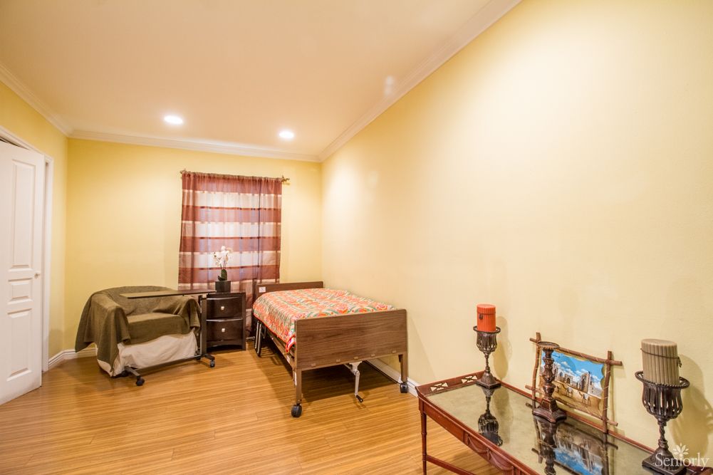 A cozy bedroom with two beds, a nightstand, and decorative items.