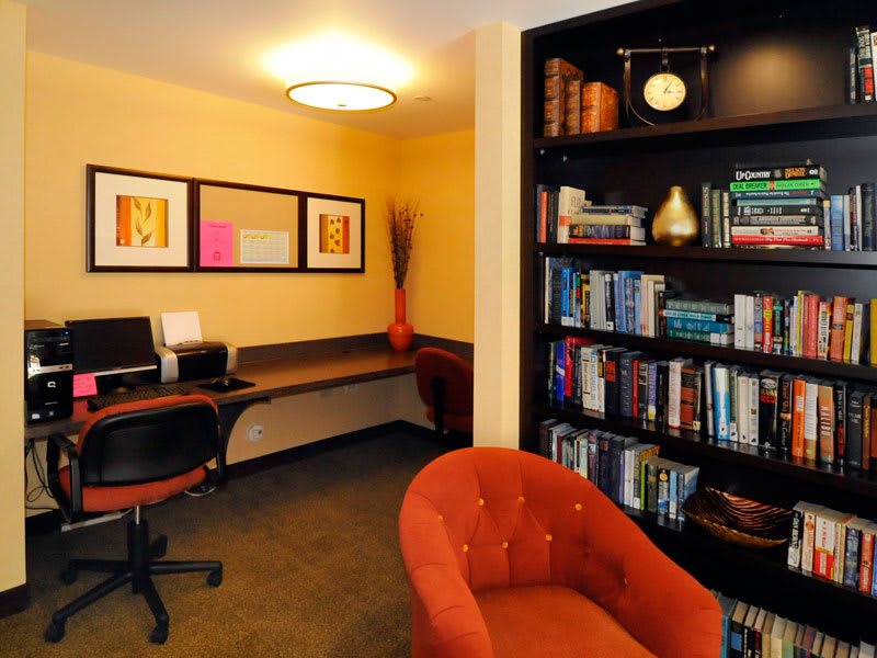 A cozy office space featuring a computer desk and a well-stocked bookshelf.