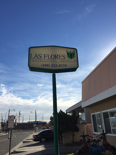 A business sign for 'As Floris' under a cloudy sky.
