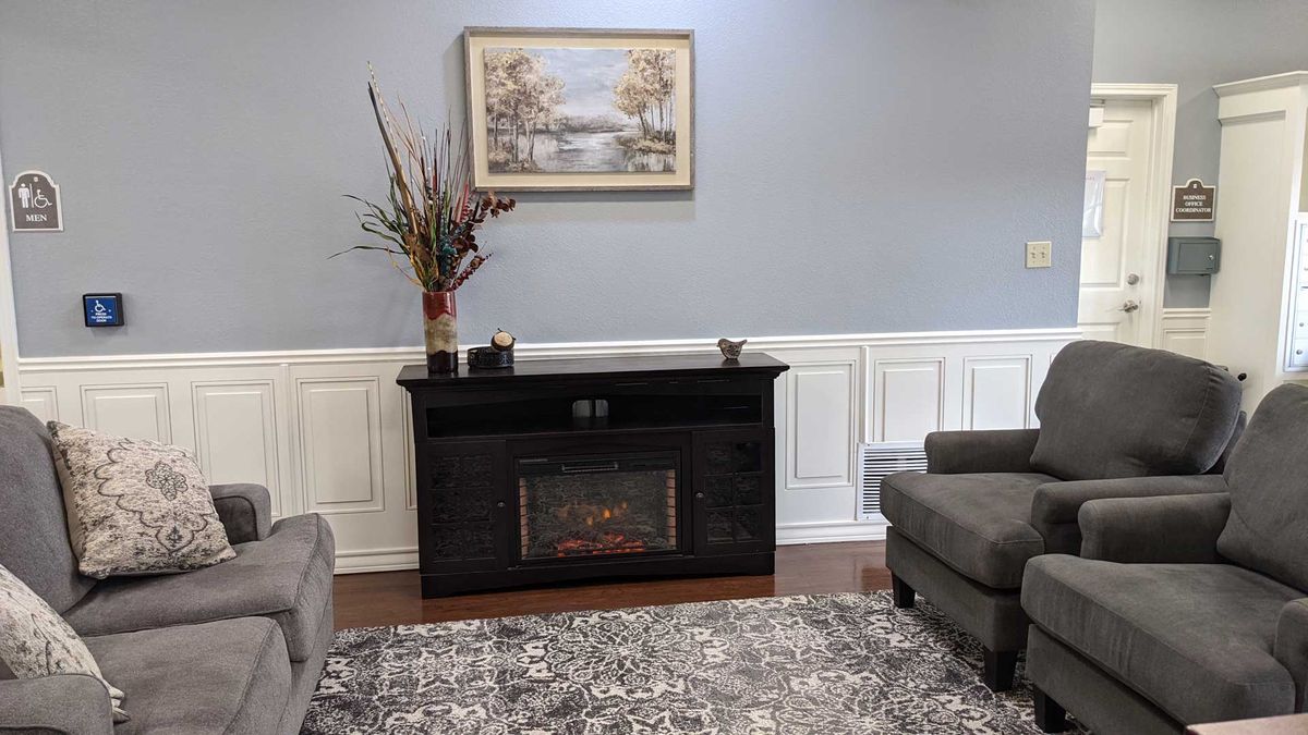 A cozy living room with a fireplace and elegant decor.
