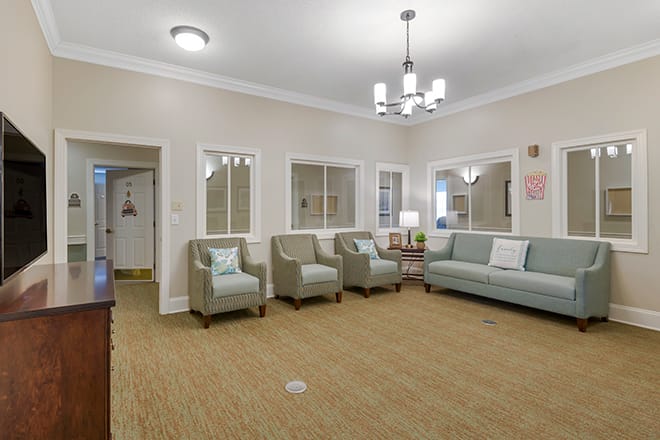 A spacious living room with comfortable seating and stylish lighting.