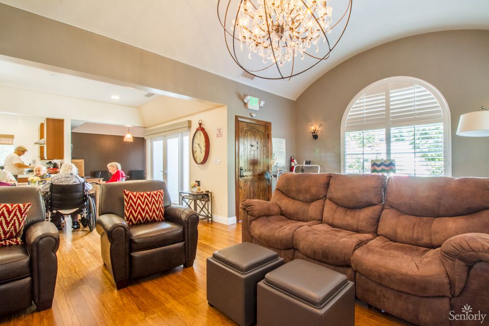 A cozy living room featuring comfortable seating, elegant lighting, and stylish decor.