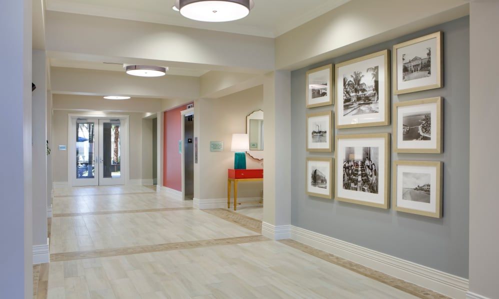 A modern hallway with framed artwork and contemporary lighting.