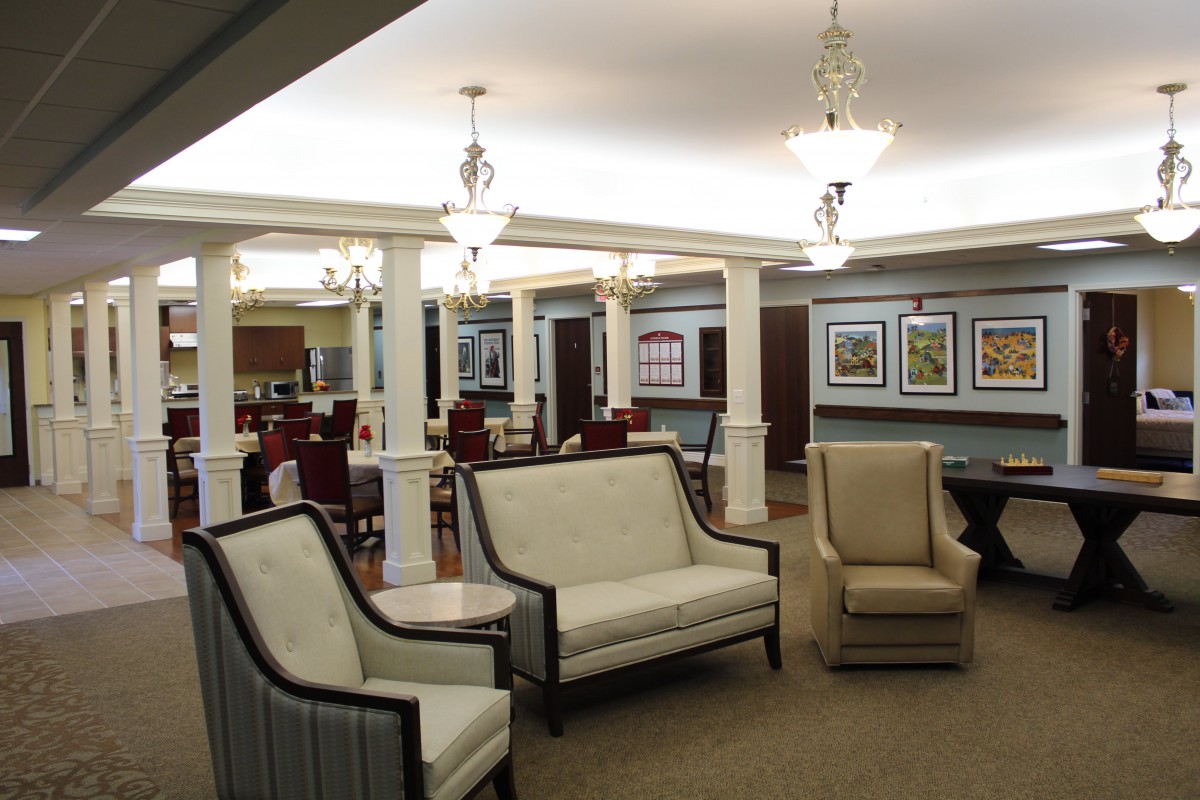 A well-lit lounge area with comfortable seating and decorative artwork on the walls.