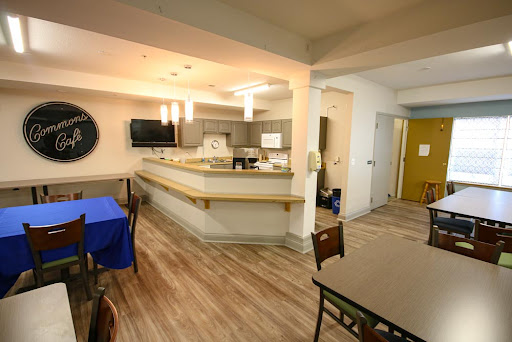 A modern kitchen and dining area featuring an open layout with wooden flooring.