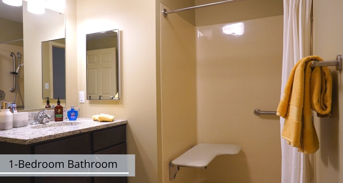 An accessible bathroom with a shower bench and vanity.