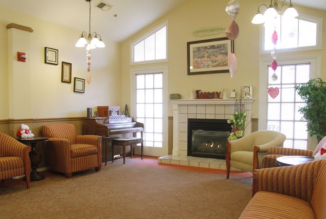 A cozy living room with a fireplace and comfortable seating.