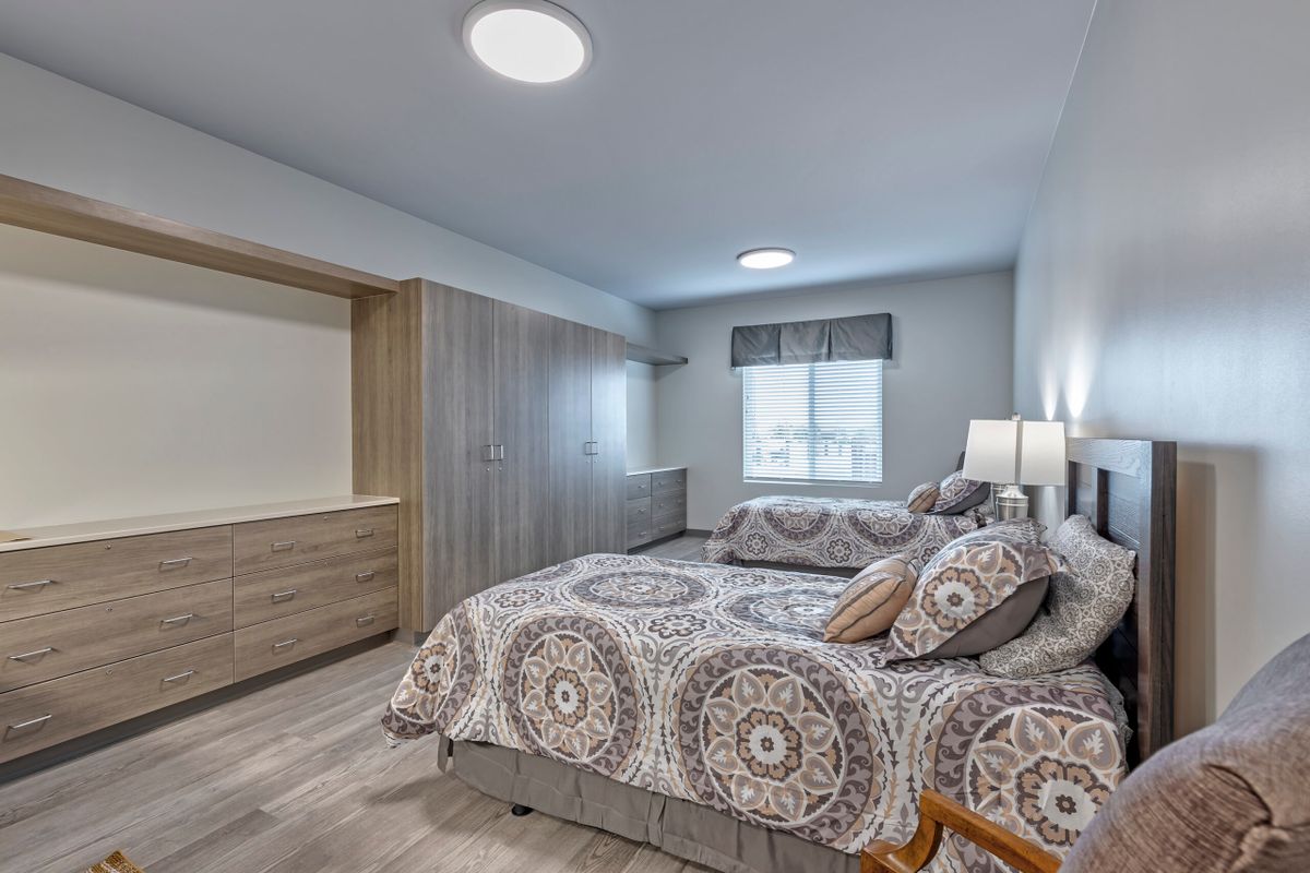 A modern bedroom with comfortable beds, stylish decor, and ample closet space.