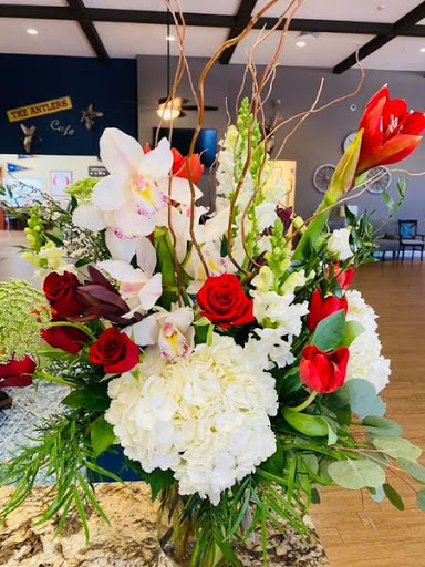 A stunning floral arrangement featuring a beautiful mix of roses and orchids, perfect for any special occasion.