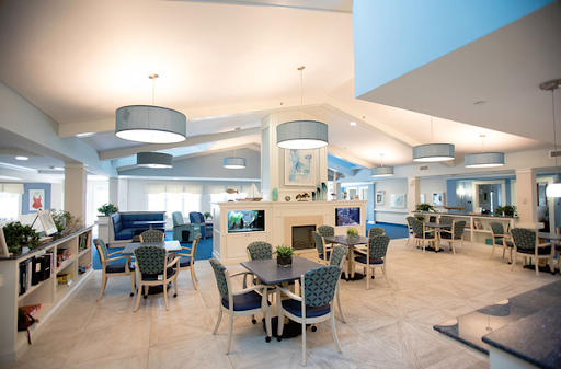 A modern dining area with blue accents and comfortable seating.