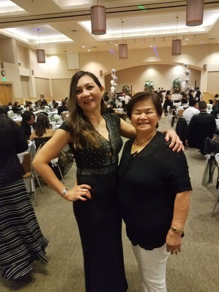 Two women posing together at a formal event.