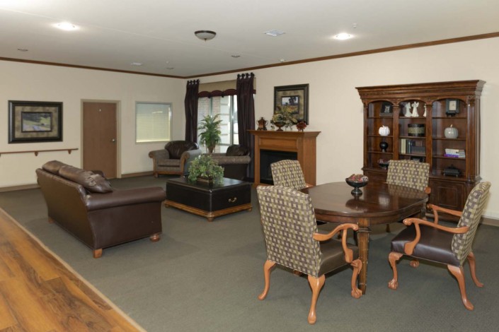A spacious living room featuring a dining area with elegant furniture and classic decor.