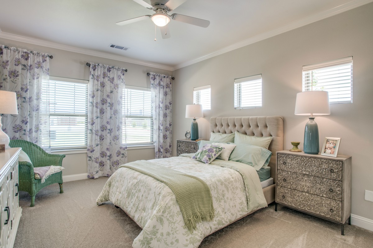 A cozy and well-decorated bedroom with soft lighting and neutral colors.