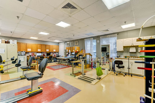 A well-equipped physical therapy room featuring exercise stations and rehabilitation tools.