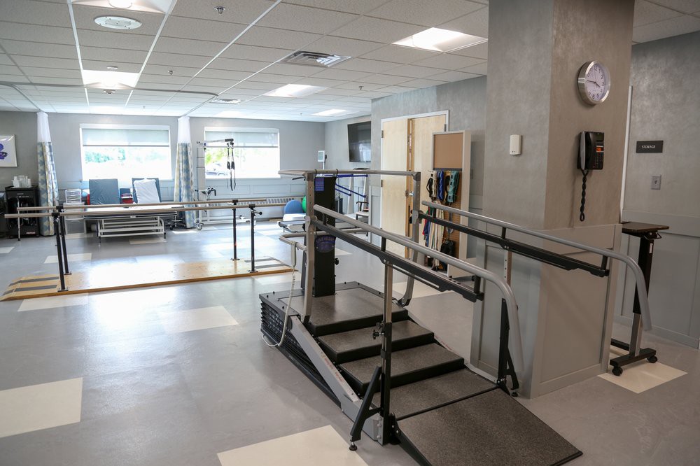 A well-equipped rehabilitation center with various exercise and mobility equipment.