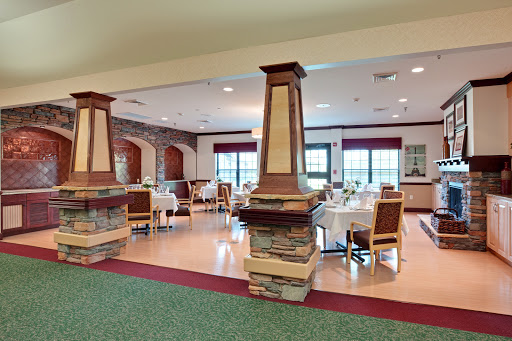 A spacious and inviting dining area featuring elegant furniture and decorative architectural elements.