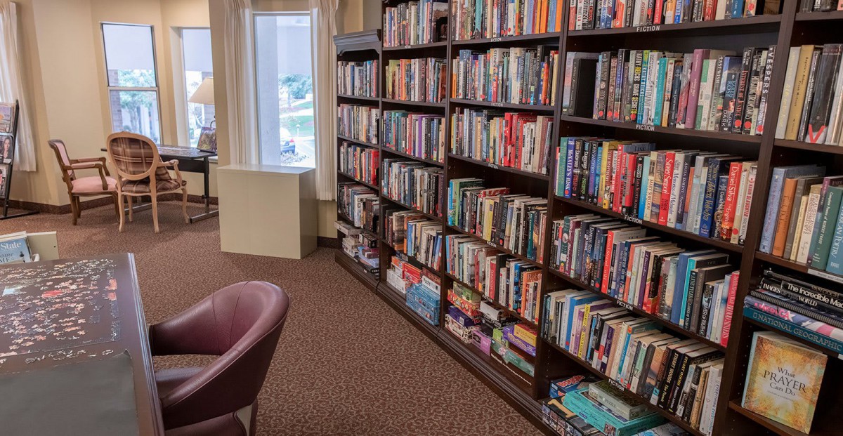 A cozy library interior with bookshelves filled with a variety of books.