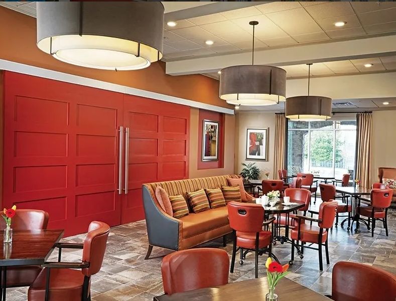 A modern restaurant interior with comfortable seating and stylish lighting.