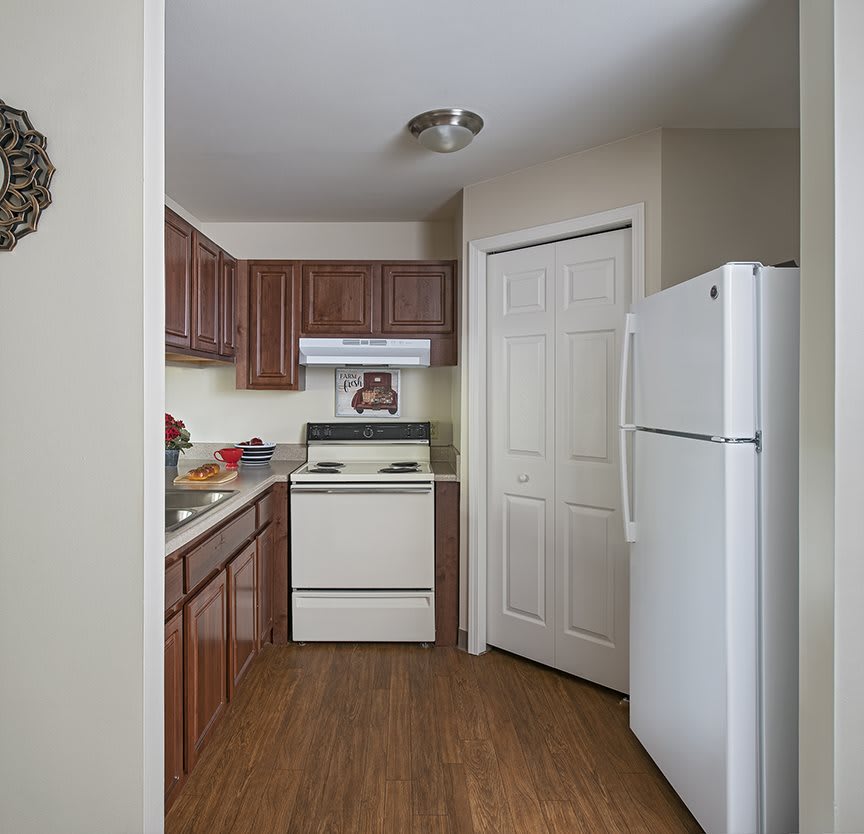 A compact kitchen with wooden cabinets and modern appliances.