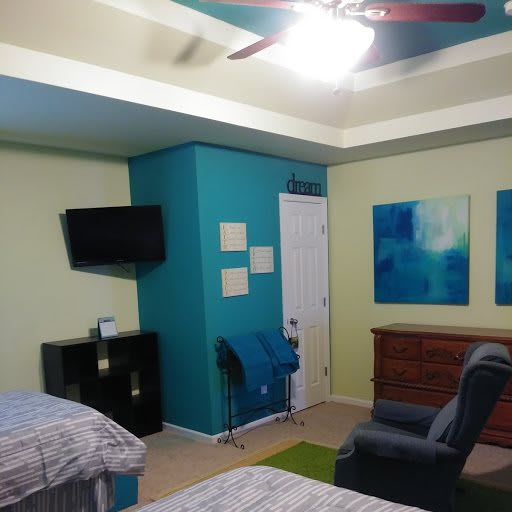 A cozy bedroom with twin beds, colorful walls, and modern decor.