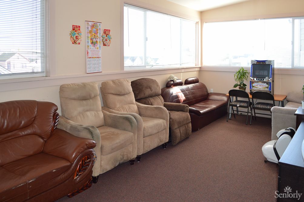 A well-lit waiting room with various seating options including recliners and a sofa.