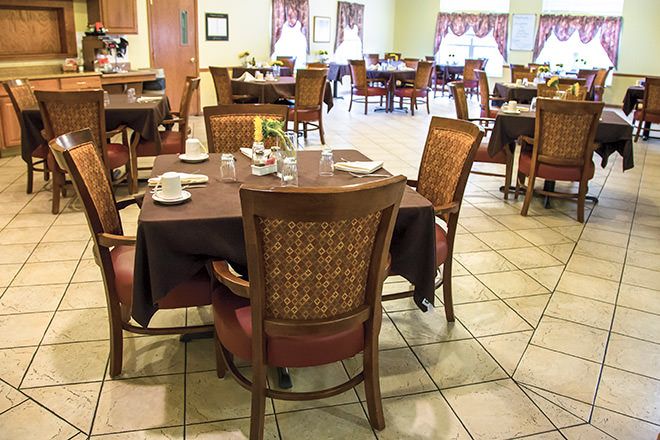 An indoor dining area with neatly arranged tables and chairs.