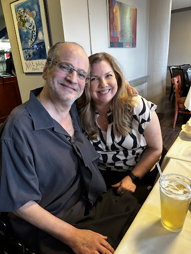 A joyful moment shared between two friends at a restaurant.