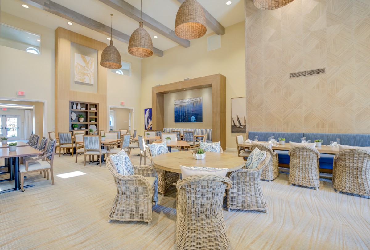 A modern and stylish lounge area with wicker chairs and pendant lighting.