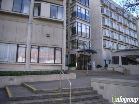 Entrance of a multi-story residential building with steps leading up to the door.