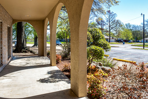 A serene porch view surrounded by lush greenery and well-maintained landscaping.