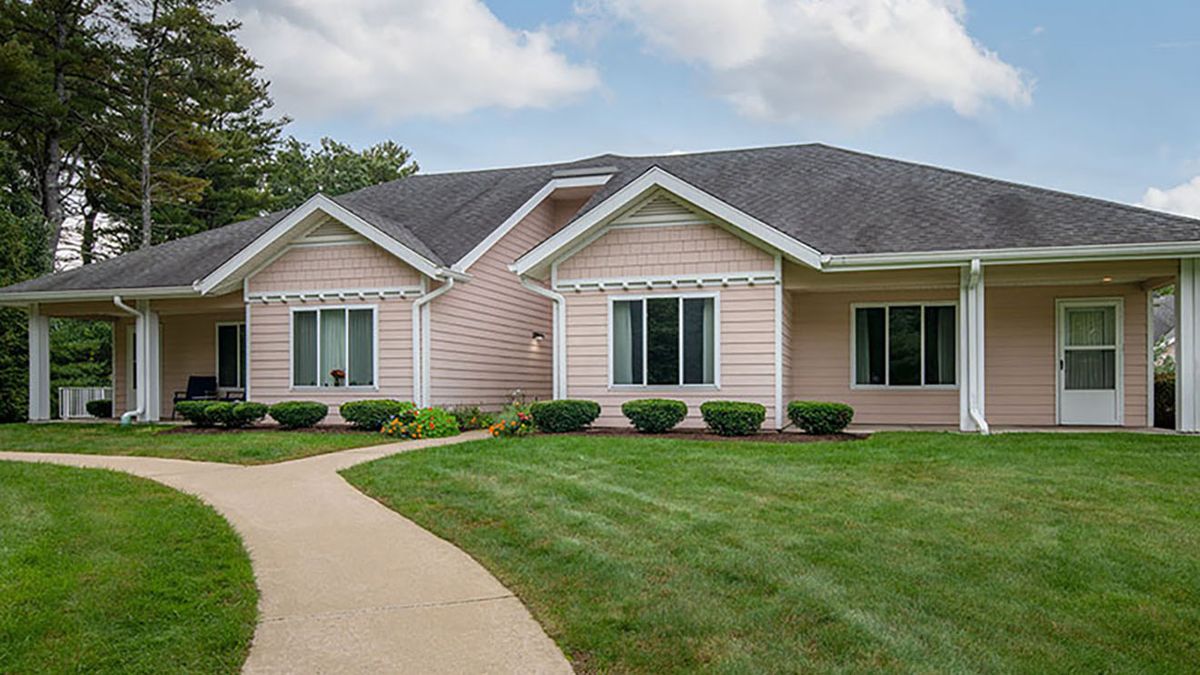 A single-story suburban house with a well-maintained lawn and walkway.