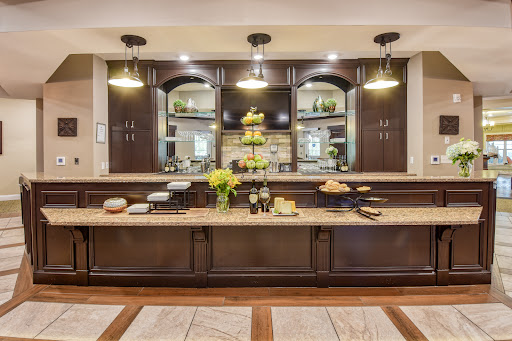 A beautifully designed modern kitchen featuring dark wood cabinetry, elegant lighting, and decorative elements.