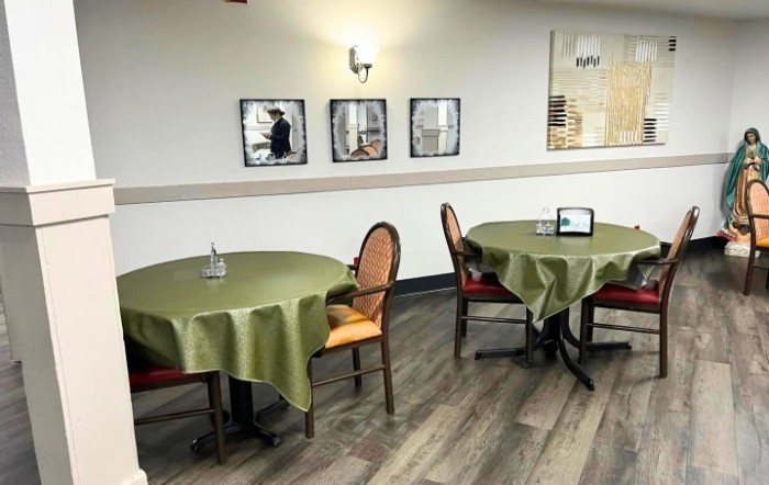A cozy dining area with green tablecloths and elegant decor.