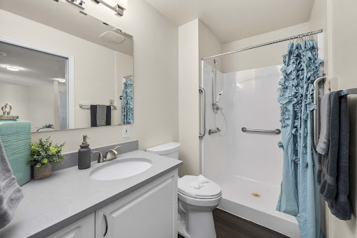 A sleek and modern bathroom featuring a shower, sink, and tasteful decor.