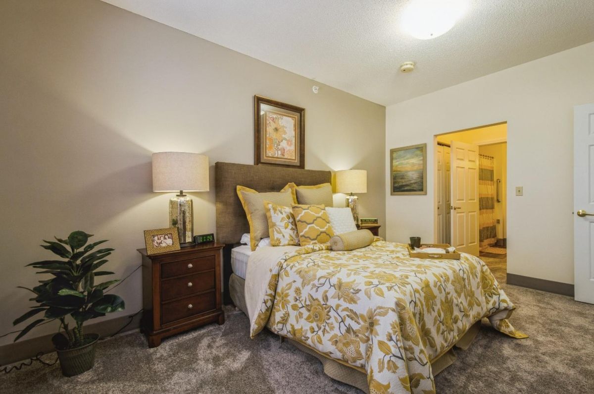 A cozy bedroom with elegant decor and warm lighting.