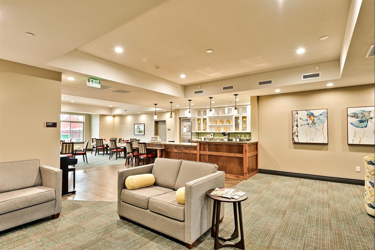 A modern lounge with a comfortable seating area and bar.