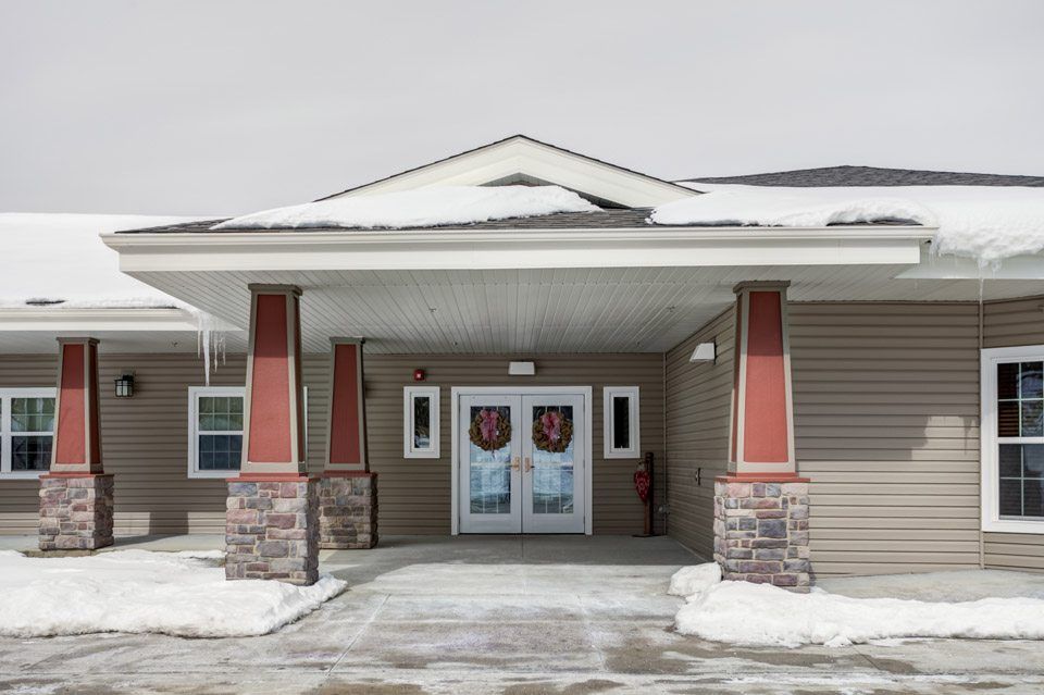 Entrance of a building with snow-covered surroundings.