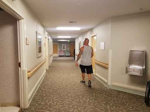 A man walking down a well-lit hallway.