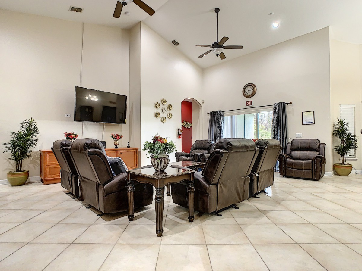 A modern living room with comfortable seating and a large TV.