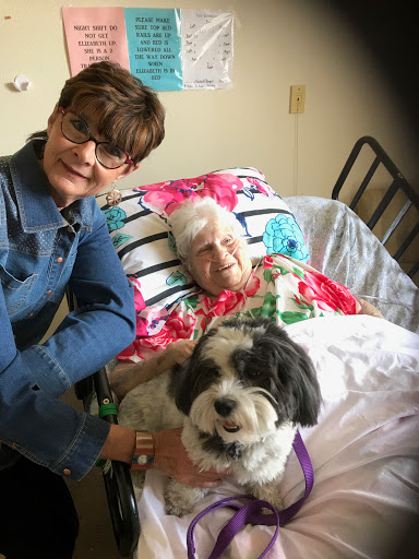 A loving companion visit at a care facility, brightening the day for both the resident and her visitor.