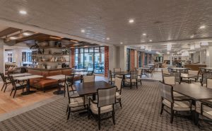 A modern restaurant dining area with neatly arranged tables and chairs.